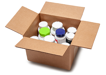 A cardboard box is open and shows bottles of prescription medicines