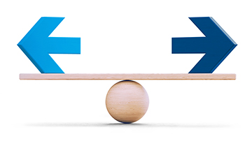 A wooden balance beam support two blue arrows on either end