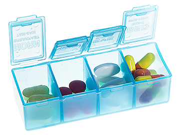 A four-section medicine container is opened and shows medicines