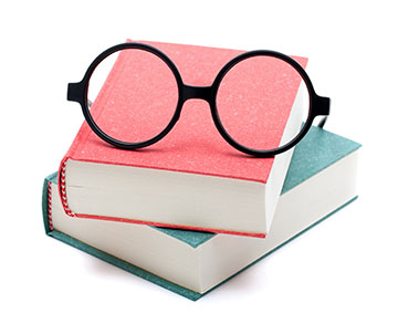 Two books stacked with glasses on top